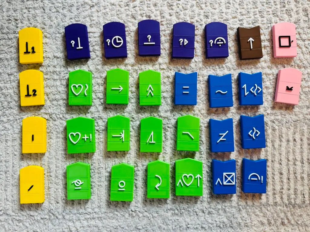 A set of 3D printed colorful tactile symbols on a grey carpet