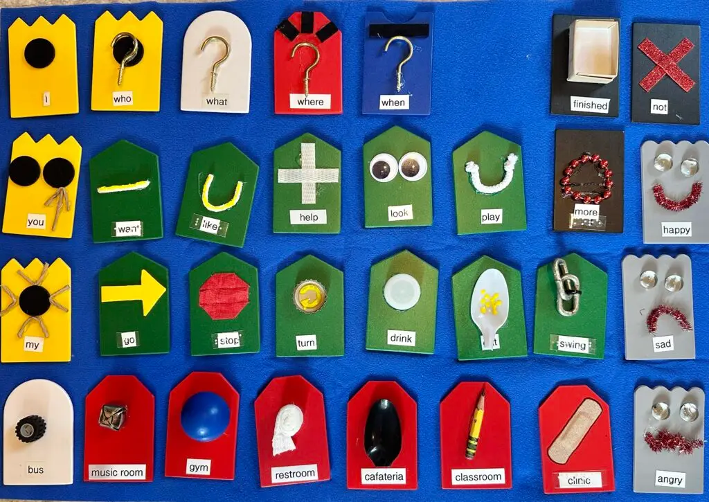 A set of colorful tactile symbols with print labels on a blue background.